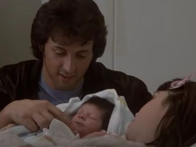 Sylvester Stallone is looking at the baby Seargeoh Stallone.